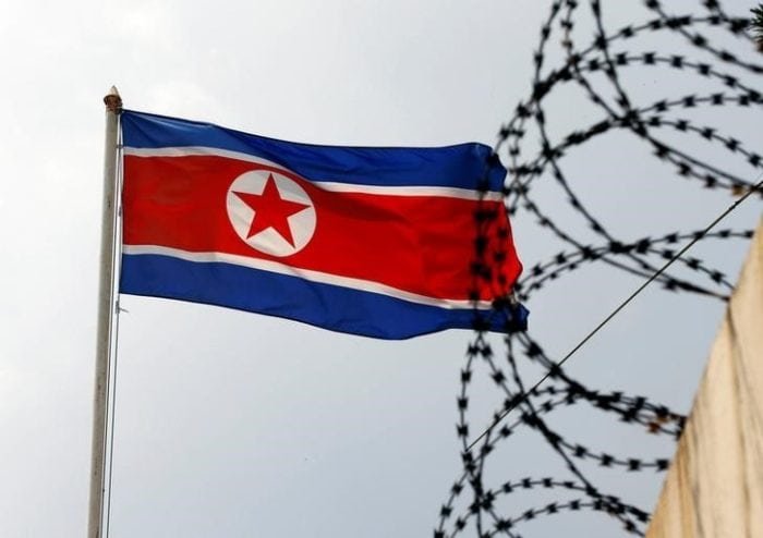 The North Korea flag flutters next to concertina wire at the North Korean embassy in Kuala Lumpur