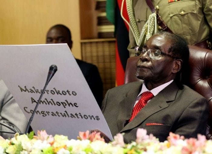 21 February 2017: Zimbabwe's President Robert Mugabe reads a card during his 93rd birthday celebrations in HararePhilimon Bulawayo/Reuters